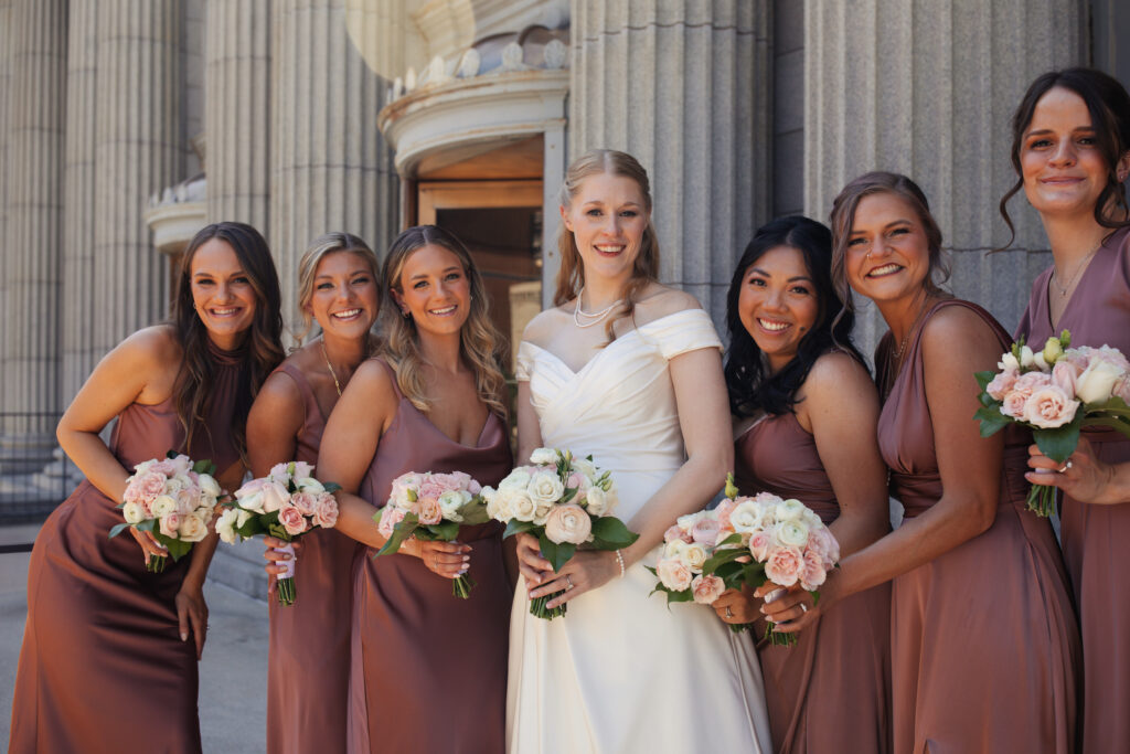 Bride with her bridesmaids at her Depot Minneapolis wedding featuring florals from Leitner's Garden Center