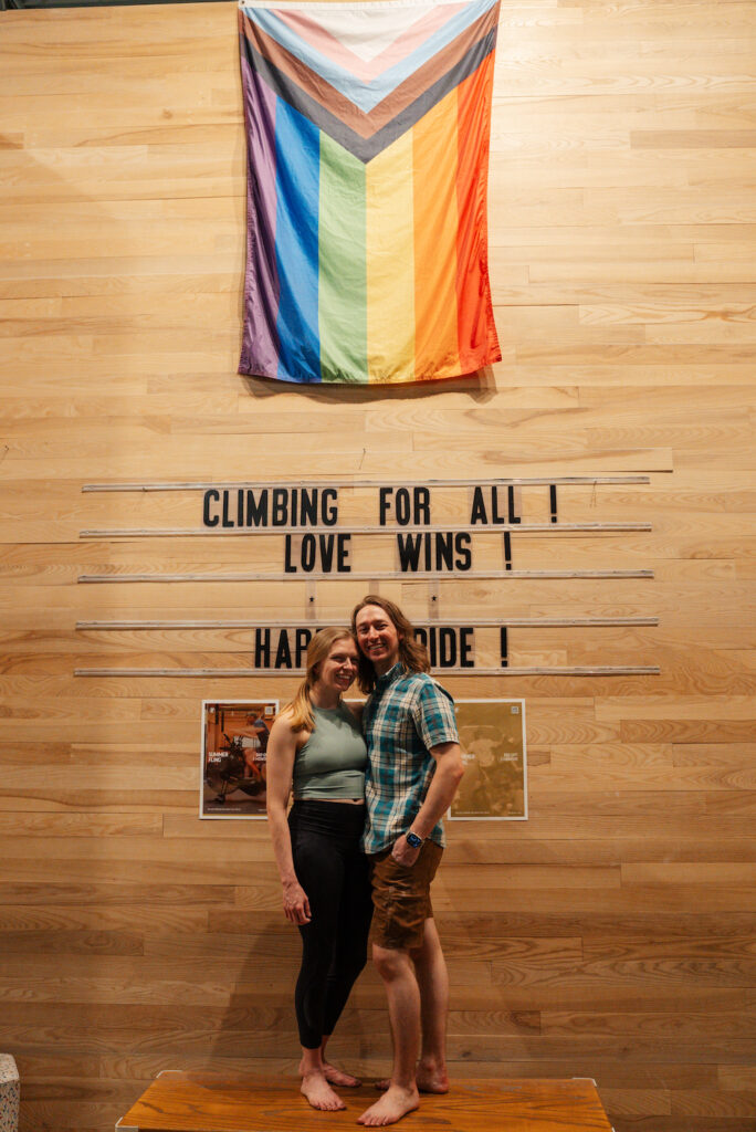 Minneapolis Bouldering Project engagement session with a progress Pride flag