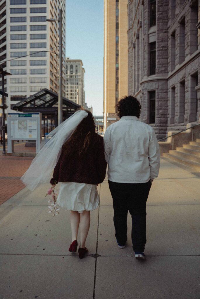 Elopement couple walking by City Hall in downtown Minneapolis, Minnesota