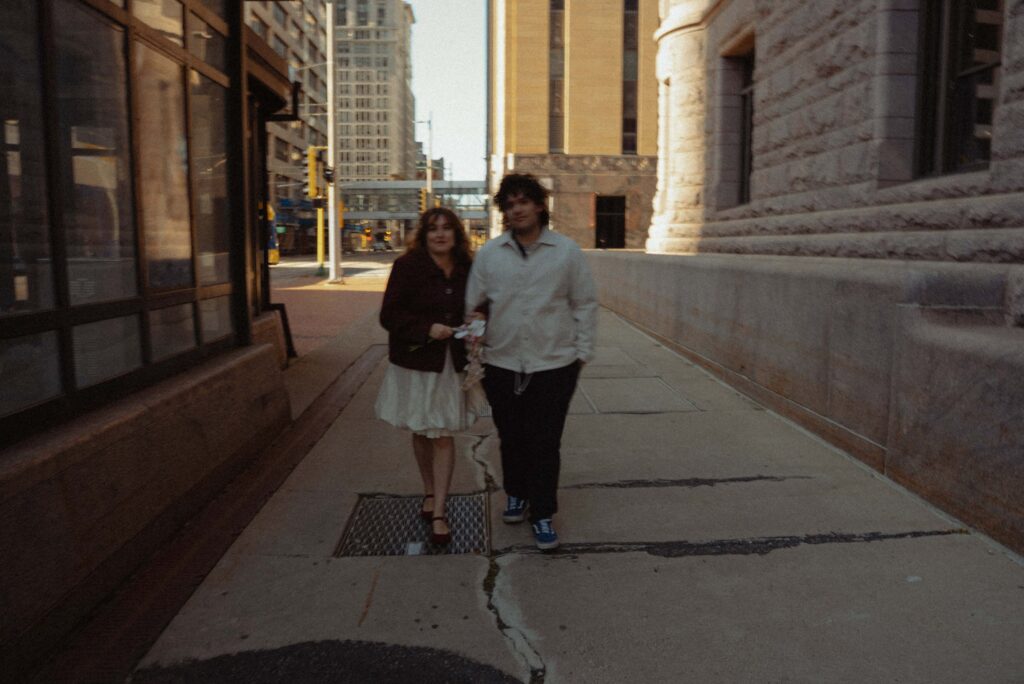 Alternative elopement couple walking in downtown Minneapolis, Minnesota