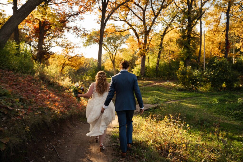 Elopement couple walking through Theo Wirth park in Minneapolis, Minnesota