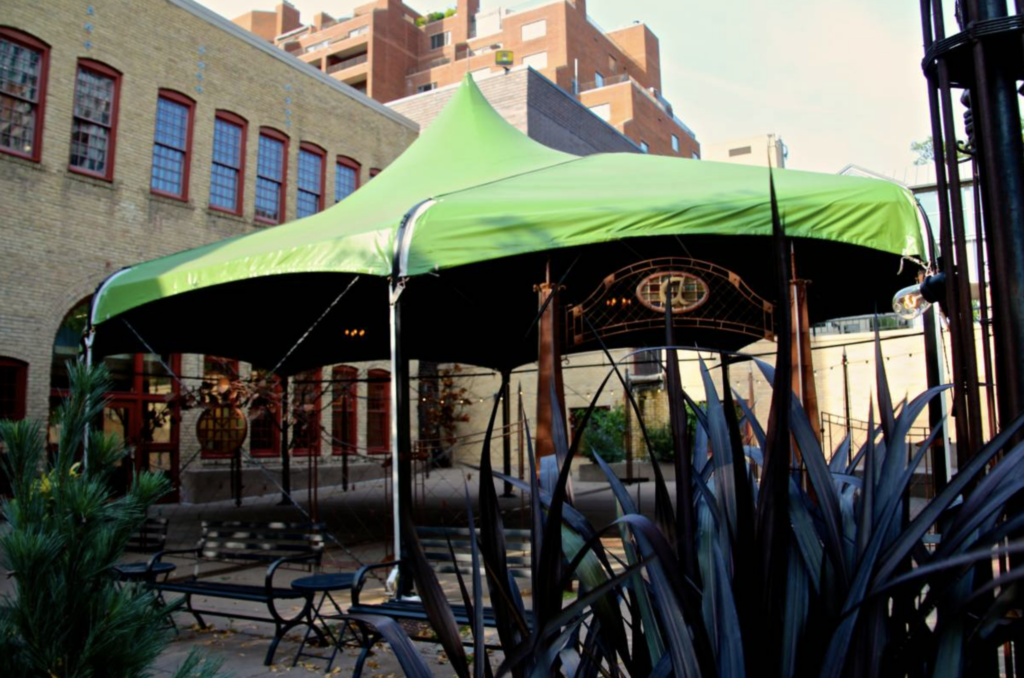 The Shasta Tent at the Aster Cafe, a micro-wedding venue in Minneapolis, Minnesota, which includes a chandelier
