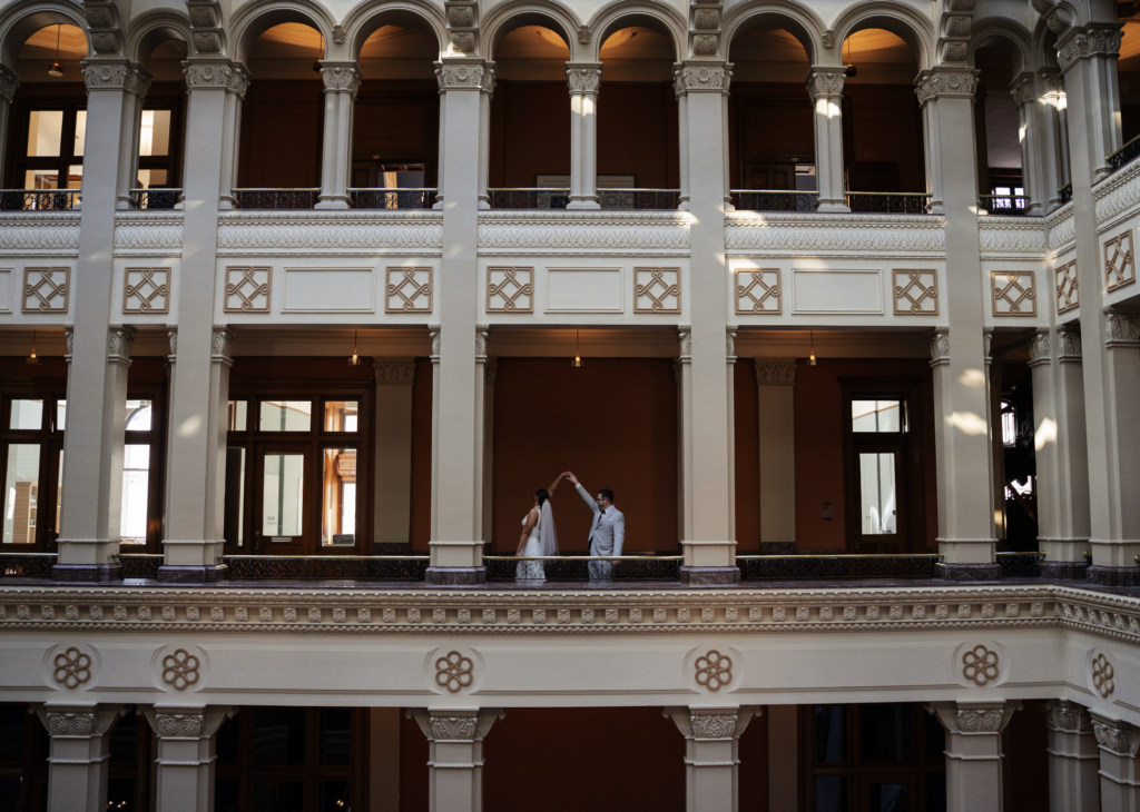 Wedding couple showing off the atrium of the Landmark Center in Saint Paul, Minnesota